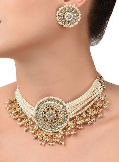 This jewelry set consists of a necklace and a pair of earringsGold-plated and white Kundan and pearls studded multistrand choker necklace, has a drawstring closureA pair of matching studs, secured with a post and back closure Necklace Length: 40 cmEarring Length: 3 cm Material: AlloyStone type: Kundan and pearlsPlating: Gold-plated Care Instructions Wipe your jewelry with a soft cloth after every use Always store your jewellery in a flat box to avoid accidental scratches Keep sprays and perfumes Choker Jewellery, Kundan Jewellery Set, Fashion Jewellery Online, Choker Jewelry, Bollywood Jewelry, Pearl Choker Necklace, Gold Necklace Women, Jewelry Choker, Kundan Jewellery