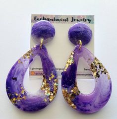 the purple and gold earrings are on display for people to see in their storeroom