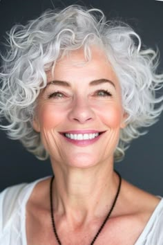 Wispy grown-out white pixie curly hairstyle for women over 60. Graduated Layered Bob Haircuts, Curly Hairstyles For 60 Year Old Women, Spiral Perm Short Hair Curly Bob, White Curly Hairstyles, Short Curly Gray Hair Over 50, Curly Gray Hair Over 50 Curls, Chin Length Curly Hair, Curly Bobs For Older Women, Platinum White Hair