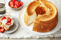 a bundt cake on a plate with strawberries next to it