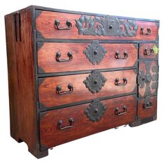 an old wooden dresser with metal handles and knobs on the front, against a white background