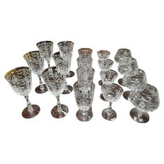 a group of glass goblets sitting next to each other on a white surface