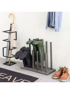 a pair of shoes and an umbrella are on the floor in front of a rack