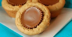 three peanut butter cup cookies on a white plate