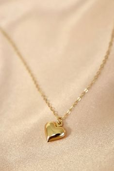 A brass puff heart charm on an 18" gold filled chain. Materials: gold filled chain, brass heart charm Length: 18" long SKU: CN1500G Everyday 14k Gold Filled Heart Charm Necklace, Dainty 14k Gold Heart Necklace With Adjustable Chain, Gold Brass Heart Charm Necklaces, Gold Brass Charm Necklace With Heart Charm, Yellow Gold Heart Charm Necklace In 14k Gold Filled, Everyday 14k Gold-filled Necklace With Heart Charm, Tiny Gold-plated Charm Necklaces, Tiny Gold Plated Charm Necklaces, Gold Heart Pendant Charm Necklace, Tarnish Resistant