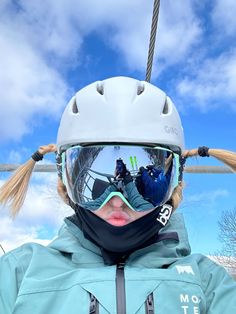 a woman wearing ski goggles and a helmet