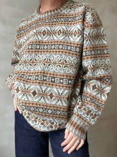 a woman is wearing a sweater with an interesting pattern on the front and back side