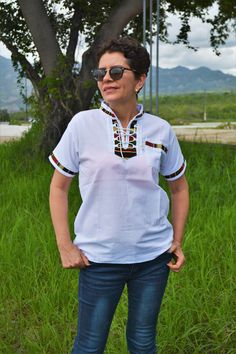 "Guatemalan T-shirts handmade, loomed with contrasting trim.Handwoven fabric accents the neck and sleeves, and across the shoulders in the back. A draw string neck that opens down to the mid chest. These comfortable relaxed-fit shirts are made with thick cotton that breathes. They are fantastic for all types of weather, especially those hot summer days. If you are in a hurry and would like to purchase a shirt ready to ship in 1 to 3 business days, I have some color and sizes available, please ta Casual White Blouse With Boho Collar, White Casual Tops With Boho Collar, White Casual Top With Boho Collar, White Boho Collar Top For Beach, Casual Boho Collar Blouse For Festival, White Summer Festival Shirt, Casual Cotton Blouse With Boho Collar, Cotton Blouse With Boho Collar And Short Sleeves, Casual Short Sleeve Top With Boho Collar