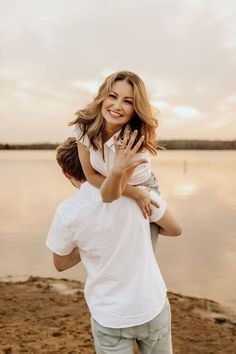 a man carrying a woman on his back by the water