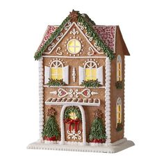 a gingerbread house with lights and decorations on the front, decorated for christmas ornament