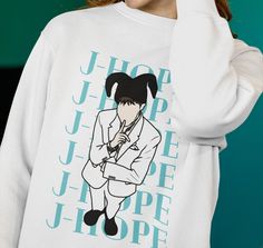 J-hope Sweatshirt, Hobi Jack in the Box,Kpop Sweatshirt, Kpop Army Sweatshirt, Bangtan Shirt, Unisex Heavy Blend Crewneck Sweatshirt Ideal for any situation, a unisex heavy blend crewneck sweatshirt is pure comfort.  These garments are made from polyester and cotton.  With its cute and beautiful design for K-pop fans, it will be the best gift for ARMY. The collar is ribbed knit, so it retains its shape even after washing.  There are no itchy side seams on these sweaters.  .: 50% Cotton 50% Polye Jhope Clothes, Kpop Sweatshirt, Kpop Graphic Crew Neck Tops, White Kpop Graphic Print Sweatshirt, Kpop Letter Print Crew Neck T-shirt, Army Sweatshirt, Kpop Fan Merchandise T-shirt With Crew Neck, Bts Merch Sweatshirts & Hoodies, Pastel Blue Color