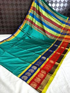 a multicolored saree is laying on a bed