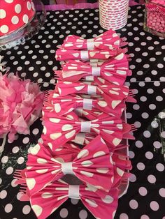 pink and white polka dot paper bows on a table