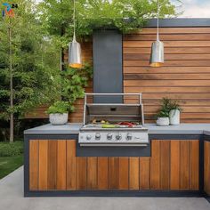 an outdoor kitchen with grill, sink and potted plants