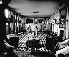 an old black and white photo of a living room with checkered flooring on the walls