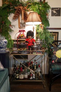 a living room filled with lots of furniture and christmas decorations on top of a table