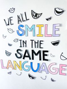 the words we all smile in the same language are cut out from different types of paper