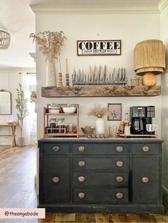 a coffee bar with plates and cups on it in a room that has wood floors