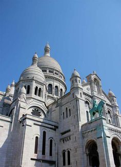 a large white building with a statue on top