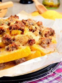 a casserole dish with sausage and pineapple toppings