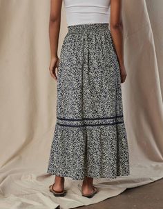 Yes, it has pockets! This cotton skirt boasts a luxurious and smooth texture, providing a soft, crisp feel against your skin. The intricate ladder lace trim adds a touch of sophistication and elevates the overall design. The shirred waistline, complete with a ruffle at the top, creates a flattering silhouette while pockets in the side seams add utility to this maxi skirt. Fit: True to size. Maxi length Fabric Details: Camp Cotton Poplin Fabric Content: 100% Cotton Details: Elastic waist with ruf Maxi Skirts Summer, Ruffle Maxi Skirt, Henley Sweater, Cotton Poplin Fabric, Tier Skirt, Cotton Skirt, Overall Dress, Fall Shopping, Fabric Details