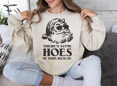 There Is Some Ho's In This House Sweatshirt, Christmas Sweater, Funny Christmas Sweatshirt Gift, Funny Santa Hoodie, Christmas Holiday Shirt HOW TO ORDER ➀ Select color ➁ Select the size (Please check size chart) ✦ True to size. Size up 1-2 sizes for an oversized look. ➂ Add to cart ✦ (Optional) "Add message to Seller" on the checkout page. GARMENT FEATURES ✦ Crew neckline ✦ Direct to garment printing - no vinyl, decal, or iron-on technique ✦ Our designs are printed on the garment to last a long Christmas Sweater Funny, Funny Christmas Sweaters, Funny Santa, Hoodie Brands, In This House, Holiday Shirt, Sweatshirt Christmas, Holiday Shirts, Funny Christmas