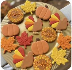 decorated cookies on a plate with autumn leaves