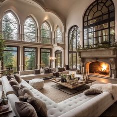 a large living room filled with furniture and a fire place in the middle of it