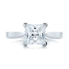 a princess cut diamond engagement ring on a white background, with the band around it's edge