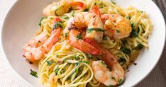 a white bowl filled with pasta and shrimp