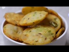 some food is in a white bowl on a table and it looks like potato chips