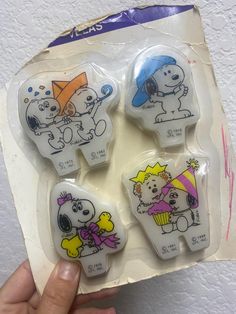 a package of four cartoon magnets in the shape of dogs