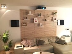 a living room filled with furniture and a wooden wall mounted on it's side