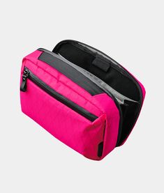 a pink and black toiletry bag on a white background