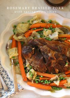 a white plate topped with meat and vegetables