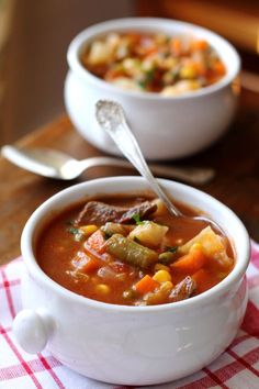 two bowls filled with soup on top of a table