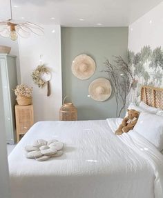 a white bed sitting in a bedroom next to two baskets