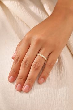 a woman's hand with a ring on it