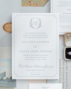 the wedding stationery is laid out on top of each other