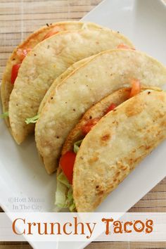 three tacos on a white plate with the words crunchy tacos written below