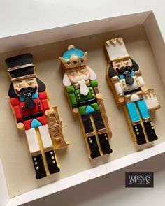 three wooden nutcrackers sitting in a box