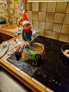 an elf is making noodles on the stove