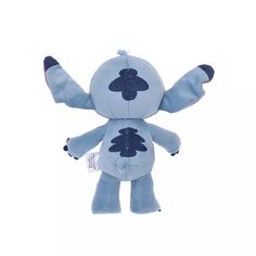 a blue stuffed animal with its arms spread out and eyes closed, on a white background