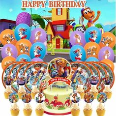 the birthday cake is surrounded by cupcakes and balloons with cartoon characters on it