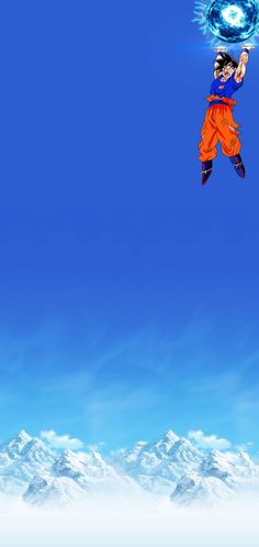 a man flying through the air while holding onto a blue ball in front of snow covered mountains