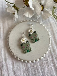 This pair of earrings is made with silver colored posts and white, yellow, green, and pink polymer clay.  This pair of earrings is perfect for anyone who loves frogs!!  If you love these earrings snatch it up before someone else does.  If you have any questions don't hesitate to contact owner and designer at HannahsJeweltique@gmail.com Visit my website at HannahsJeweltique.com White Fun Polymer Clay Earrings, Green Fun Earrings For Gifts, Green Fun Earrings For Gift, Novelty White Polymer Clay Earrings, Fun Green Earrings For Gifts, Fun Green Earrings For Gifting, White Polymer Clay Fun Jewelry, White Polymer Clay Jewelry In Fun Style, Fun White Polymer Clay Jewelry