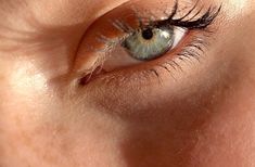 a woman's eye is shown with long lashes