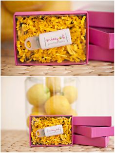 two boxes filled with yellow flowers on top of a table