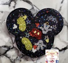 the mickey mouse ears are decorated with sequins and sparkles on top of marble