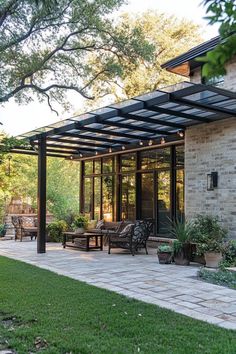 A cozy patio with outdoor seating and potted plants under a pergola with string lights. Covered Patio Ideas On A Budget, Pergola Cover Ideas Waterproof, Cheap Patio Cover, Outdoor Canopy Ideas, Backyard Patio Cover, Covered Outdoor Patio Ideas, Covered Pergola Patio, Outdoor Dining Patio, Patio Cover Ideas